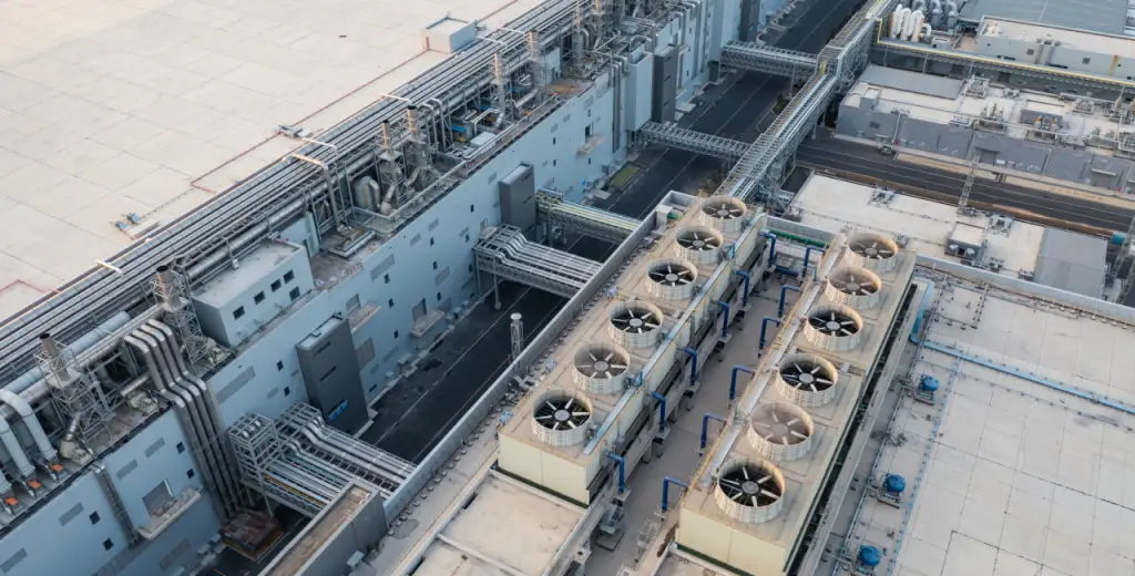 An aerial view of a sustainable industrial building, highlighting its size and eco-friendly features.