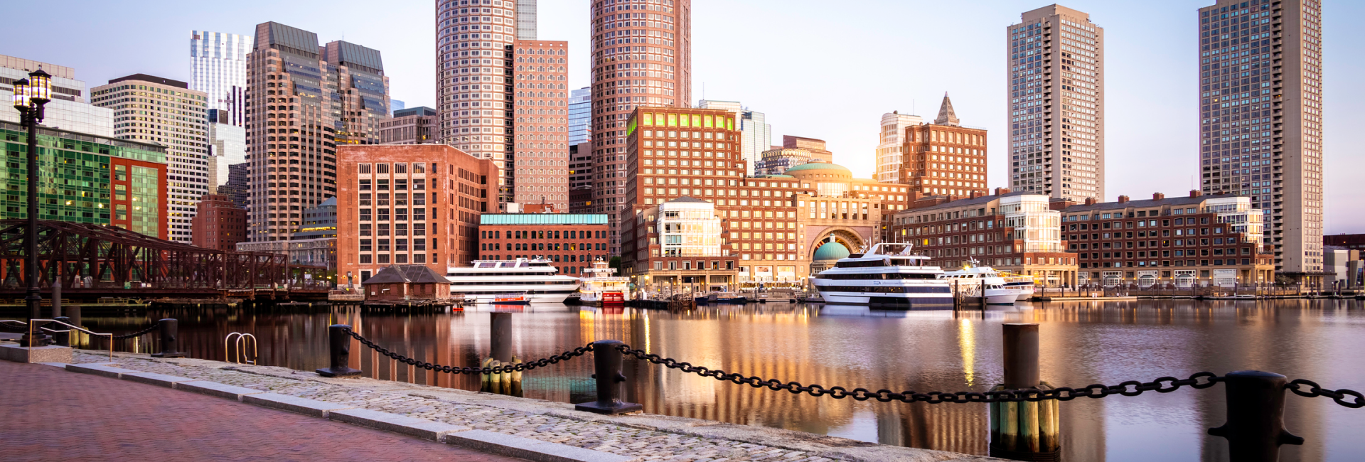 Boston skyline at sunset with net zero buildings, showcasing sustainable architecture and energy efficiency.